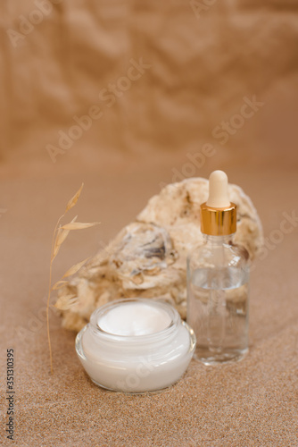 Caring cosmetics in an oyster shell on the sand. Eco-friendly organic cosmetics.