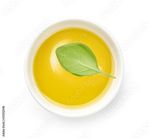 Wallpaper Mural Olive or vegetable oil in white bowl. Top view of oil with basil leaf isolated on white background. Torontodigital.ca