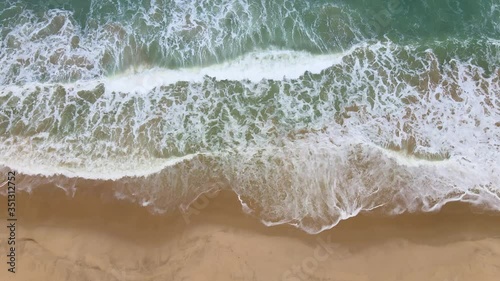 4K UHD Aerial drone view tropical beach big Waves crashing empty beach from above. 