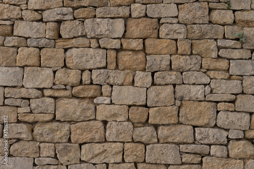 Close-up of old beige wall with stacked stones