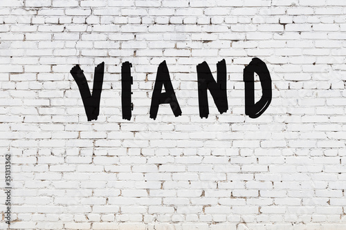 Canvas Print White wall with black paint inscription viand on it