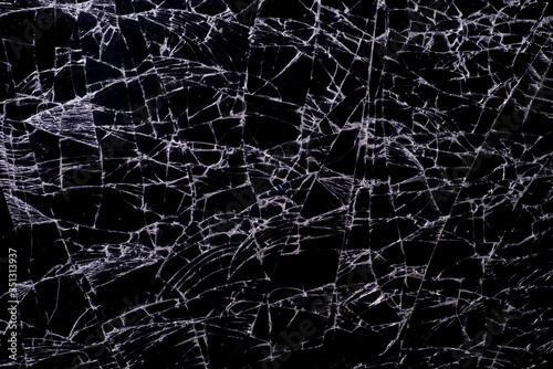 close up textures of broken black glass, with white lines on black glass, macro mode.