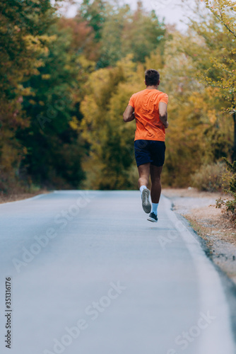 Man running on road in beautiful nature