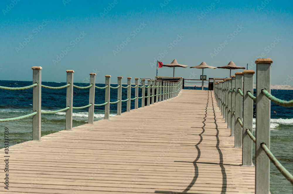 Obraz premium Pier at the hotel .Sharm El Sheikh. Photo on a sunny day. Mountains and the sea..Holidays in 2018.