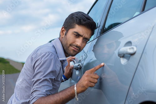 worried funny looking man obsessing about cleanliness of his car