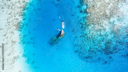 Aerial view of a ship wreck and a boat near Keyodhoo, Vaavu Atoll, Maldives, Indian Ocean with people snorkeling photo