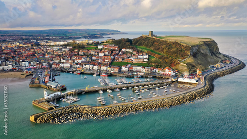 Aerial view of Scarborough harbour with lighthouse and castle, UK photo