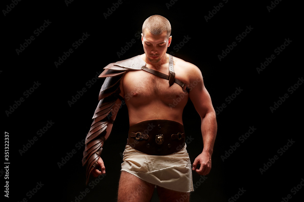 Fototapeta premium Gladiator with sword and armor on a black background