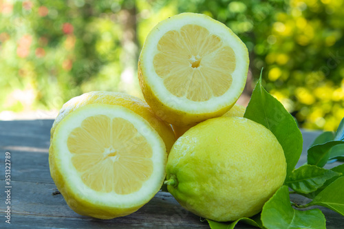 natural lemons with green leaves, fruit and citrus