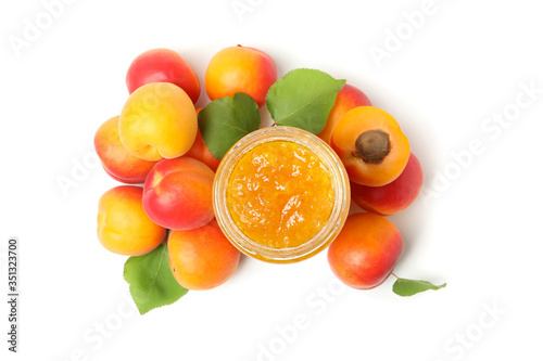 Glass jar with jam and apricots isolated on white background