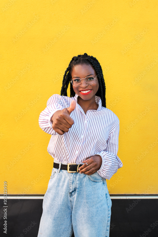 Portrait of young afro american woman in the street. Portrait of young afro american woman in the street.