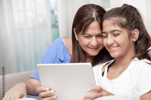 mother and daughter using laptop