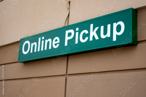 Sign noting a place to park to pick up food at grocery for socially distance during quartine for COVID-19 corona virus. St Paul Minnesota MN USA