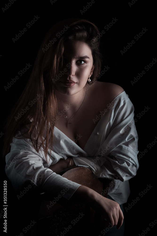 Beautiful model posing over black background. Portrait Beautiful model posing over black background. Portrait