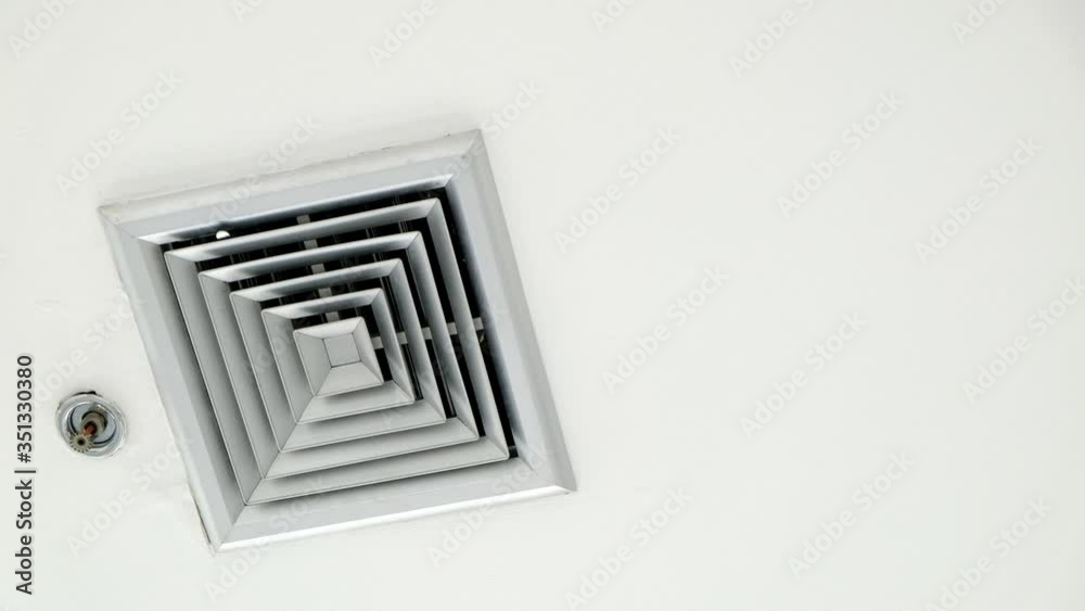 Air vent on a ceiling, pans to air vent cover on office ceiling, Plastic ventilation grid, piece of home ventilation system. cooling ventilation. Air vent on a ceiling, pans to air vent cover on office ceiling, Plastic ventilation grid, piece of home ventilation system. cooling ventilation.