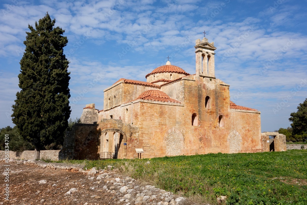 Metamorphosis Sotiros church in Pylos Nestor Palace (Niokastro Navarino) and trees in Greece at sunny day with blue sky