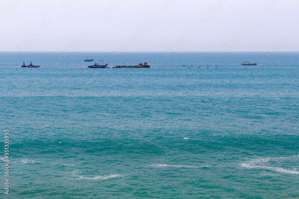 View of the ships in the Atlantic Ocean near Morocco in sunny day.