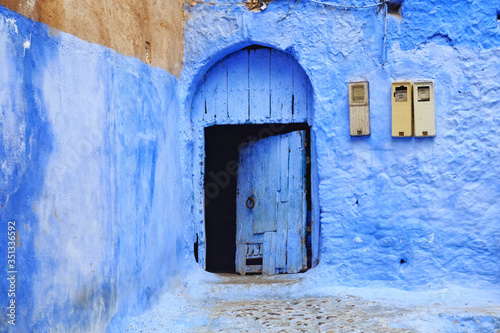 View of the old door in Medina quarter in Chefchaouen, Morocco. The city, also known as Chaouen is noted for its buildings in shades of blue and that makes Chefchaouen very attractive to visitors. © Renar