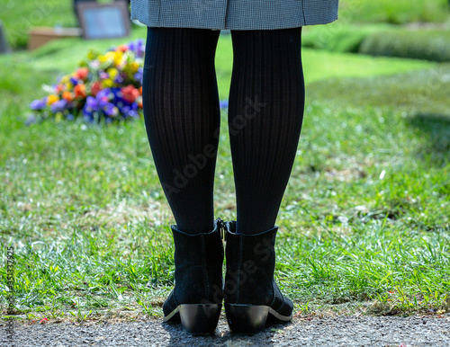 legs of woman facing grave