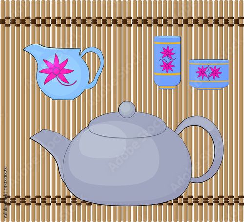 Items for a Chinese tea ceremony on a bamboo mat.