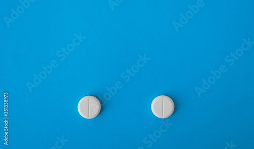 two tablets which looks like eyes on blue background.