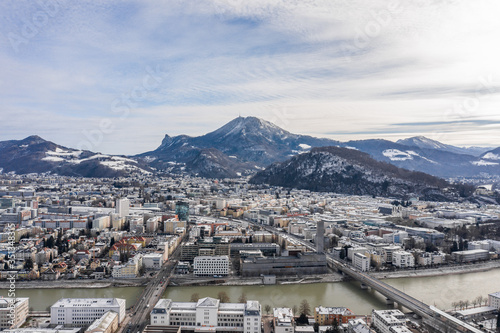 Aerial drone shot view of Salzburg northern city with view of Gaisberg Summit and Kapuzinerberg hill in winter