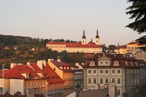 Prague, capitol of Czech republic. Very beautiful place in the Lesser Town with Strahov Monastery in the background, Picture is taken from Prague castle during sunny spring sunrise in golden hour.