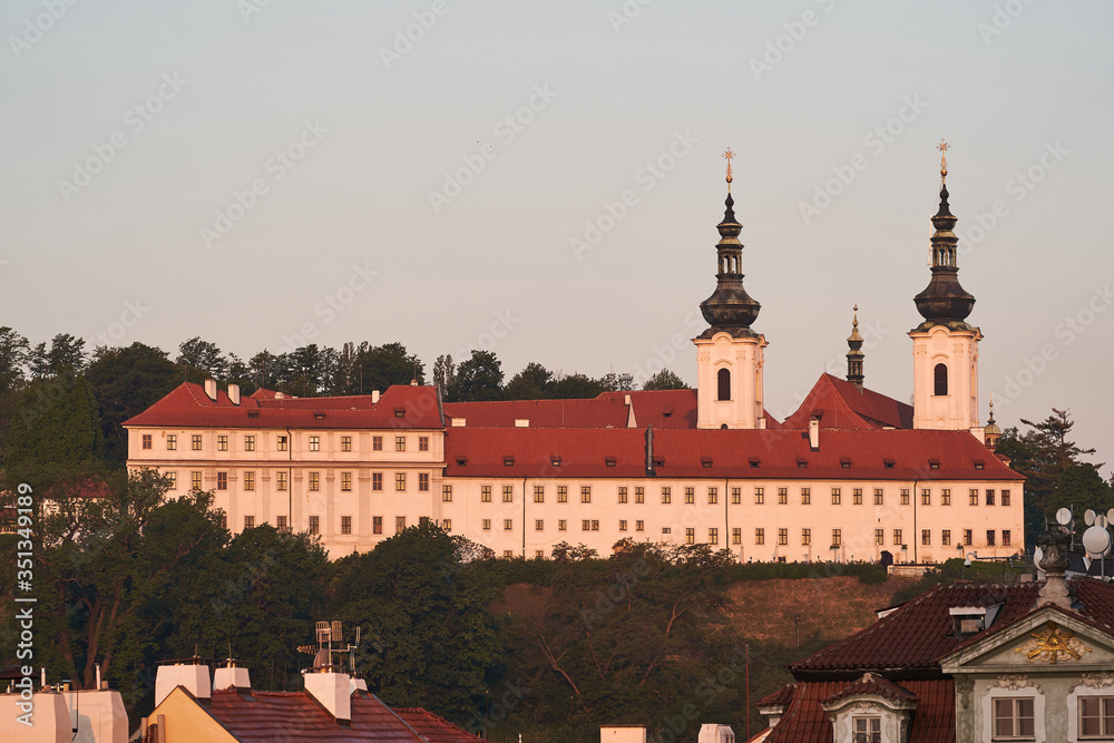 Landscape Picture of Strahov monastery in Prague, capitol of Czech republic taken during the spring sunrise in golden hour.  It is a Premonstratensian abbey founded in year 1143 near to Prague castle.
