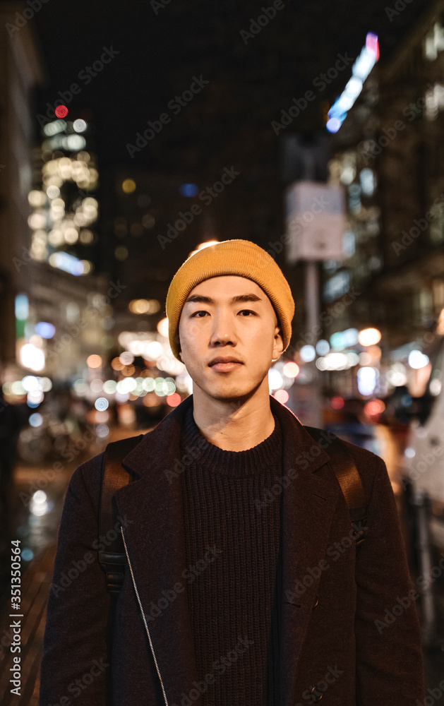 Portrait of stylish man with yellow hat in the city at night Portrait of stylish man with yellow hat in the city at night
