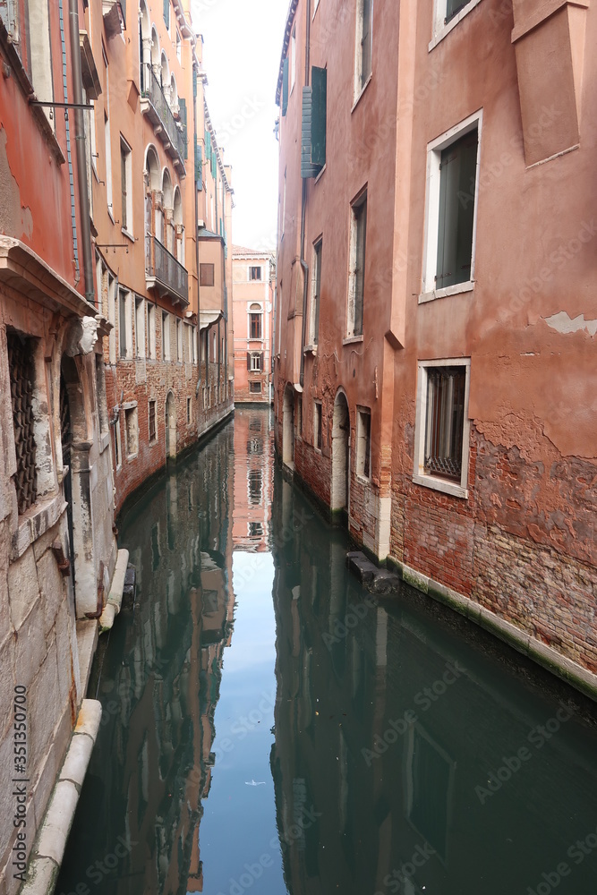 Canals through narrow streets of Venice