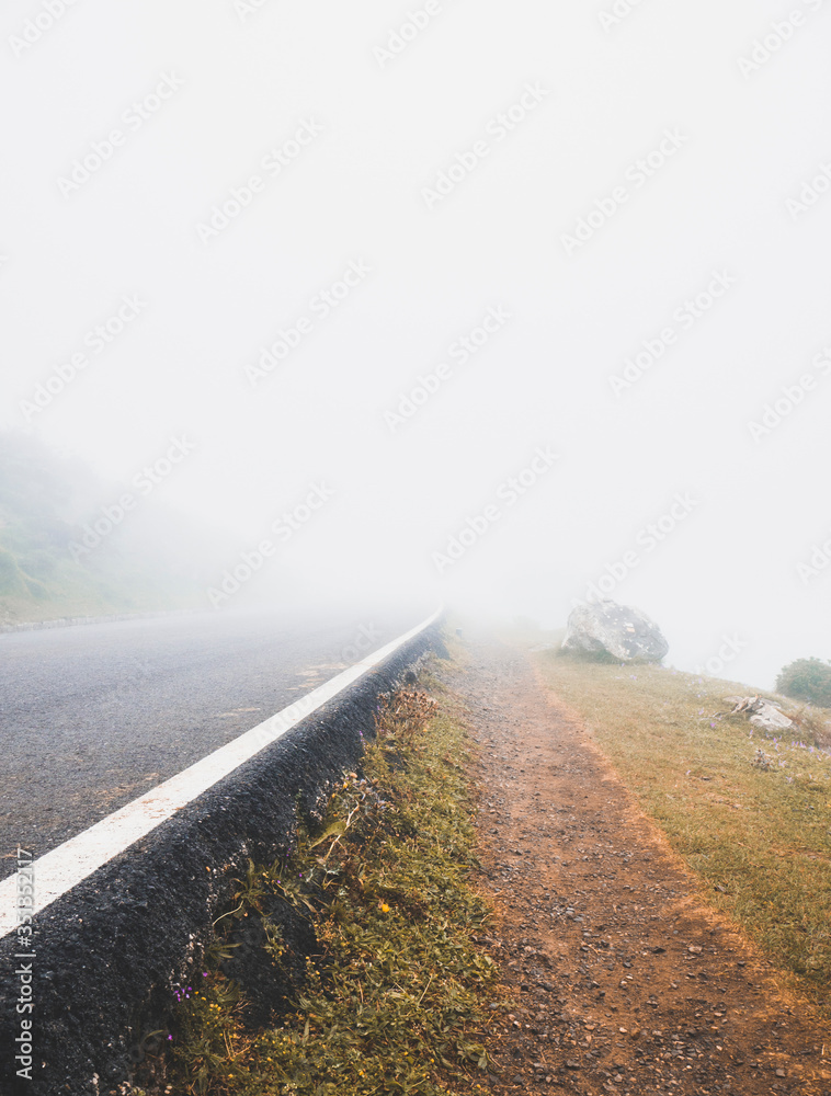 Spain, Cantabria, Thick fog shrouding asphalt highway in Picos de Europa Spain, Cantabria, Thick fog shrouding asphalt highway in Picos de Europa