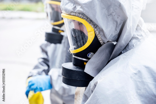 Cleaning staff desinfecting hospital against contageous virus, wearing protective clothing