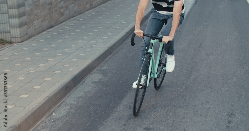 Naklejka premium Young hipster man riding bike