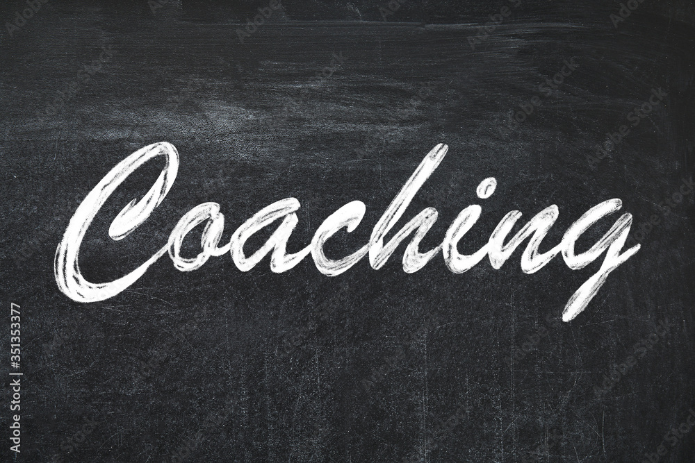 Obraz premium Adult learning. Word Coaching written on black chalkboard