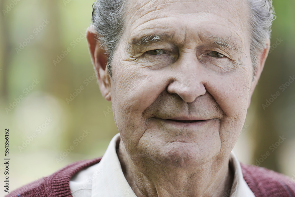 Germany, Cologne, Portrait of senior man in park, close up Germany, Cologne, Portrait of senior man in park, close up