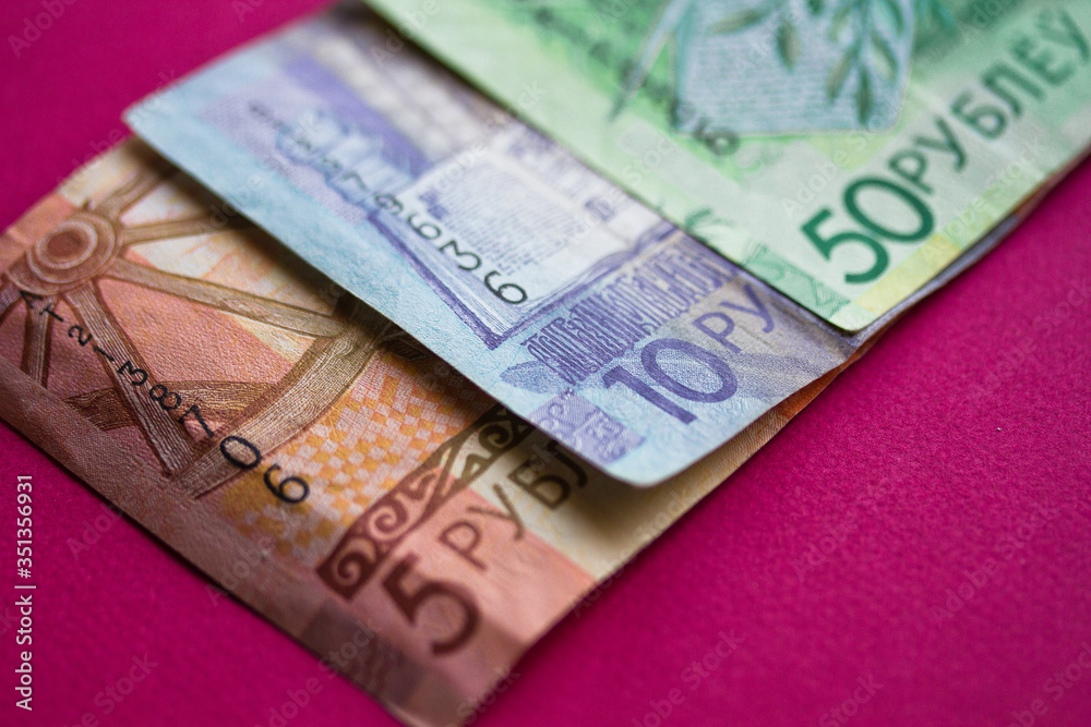 Obraz premium New banknotes and coins of the Belarusian ruble. The redenomination of the Belorusian ruble since July 1, 2016. Top view with copy space.