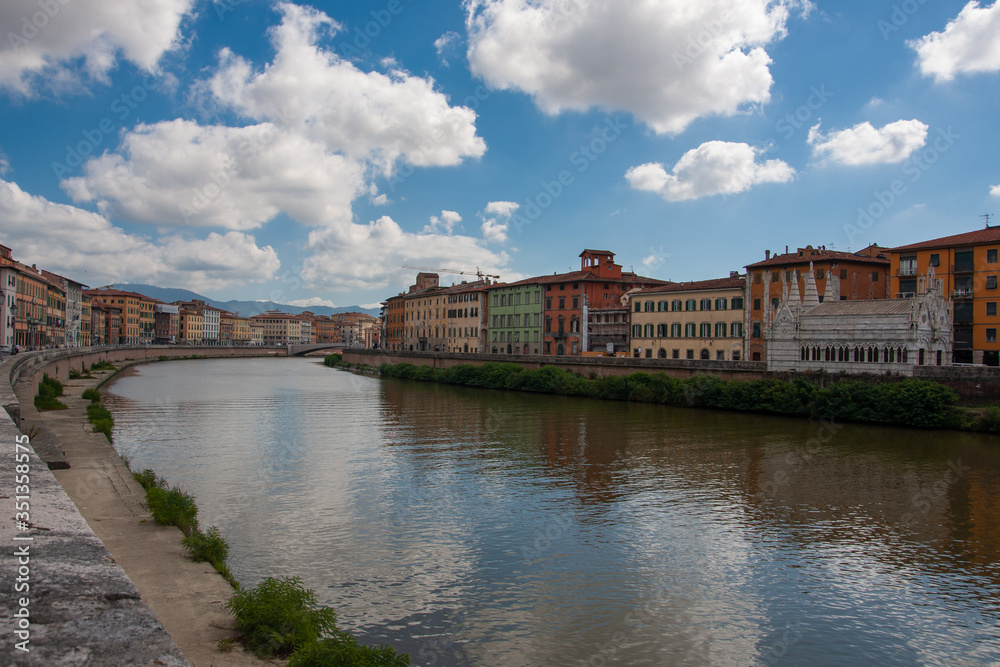 The Arno River that runs alongside the houses of Pisa