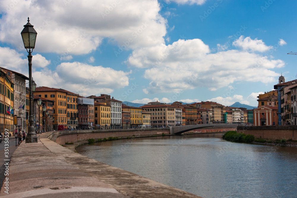 Fototapeta premium The Arno River that runs alongside the houses of Pisa