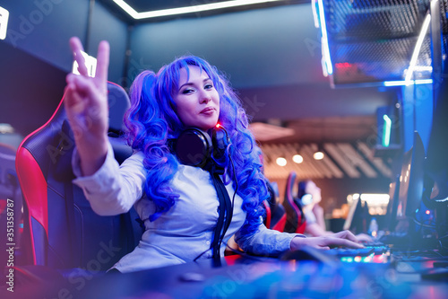 Streamer anime cosplay woman professional gamer playing online video games computer, neon color