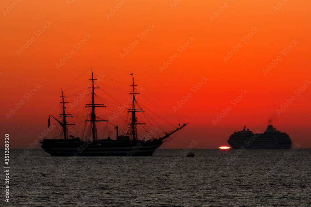 The ship of the Italian Navy Amerigo Vespucci, at sunset, in front of the city of Livorno