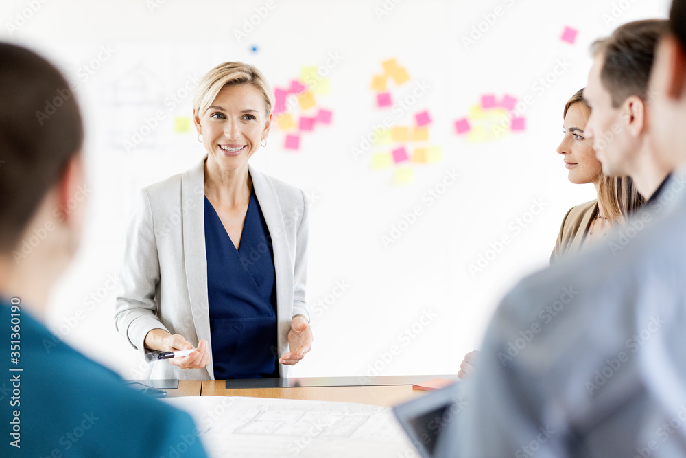 Businesswoman leading a meeting in office Businesswoman leading a meeting in office