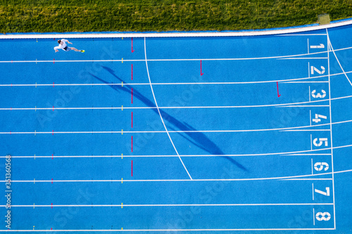 Top view of runner on blue tartan track