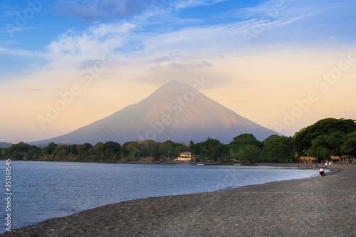 The peak of Concepcion volcano and a black sand beach on Ometepe Island, Lake Nicaragua, Nicaragua, Central America photo