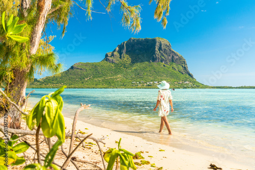 Woman walking on tropical sand beach, Ile aux Benitiers, La Gaulette, Le Morne, Black River, Mauritius, Indian Ocean, Africa photo