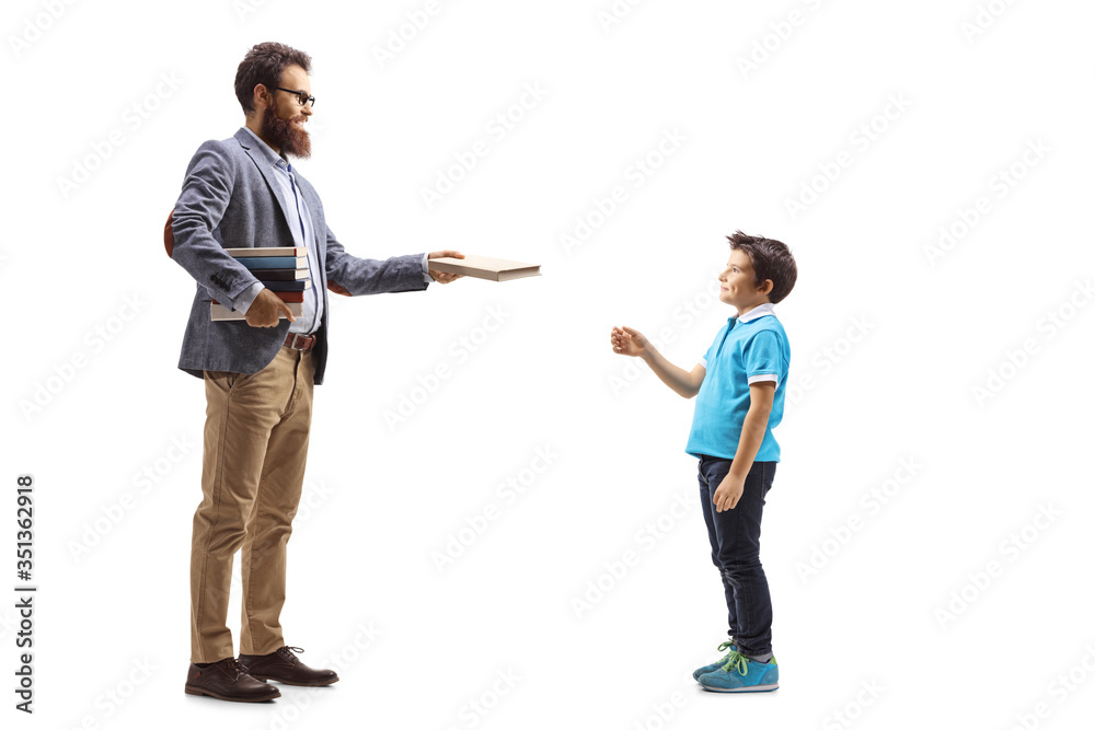 Bearded male teacher giving a book to a boy Bearded male teacher giving a book to a boy