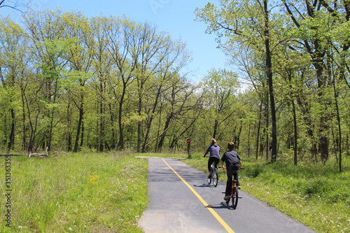 Mother and son riding bicycles on the North Branch Trail at Miami Woods in Morton Grove, Illinois