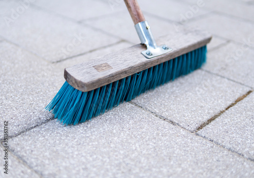 blue brush used for cleaning pavemnet photo