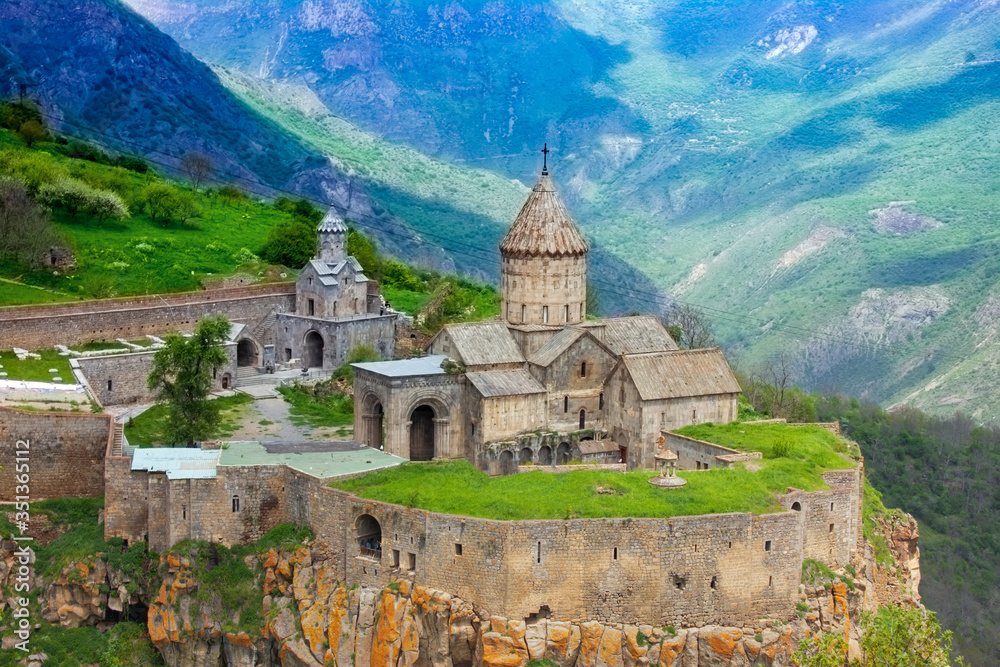 Ancient monastery in setting sun. Tatev. Armenia