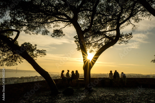 Porto, Portugal. People enjoy the beautiful views of the old town, the river and the bridge at sunset