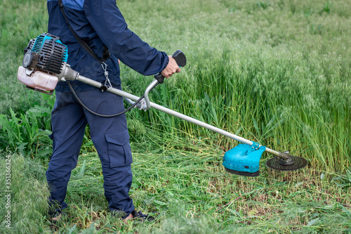 grass mowing process with gasoline trimmer